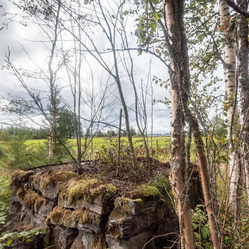 Åsmusin mäellä oleva vanha hellamuuri kertoo paikalla seisseestä talosta. Muuri ei toki ole keskiajalta vaan se on myöhäisempää perua. 1300-luvulla asutus sijaitsi ylempänä mäellä eikä tässä kohtaa.